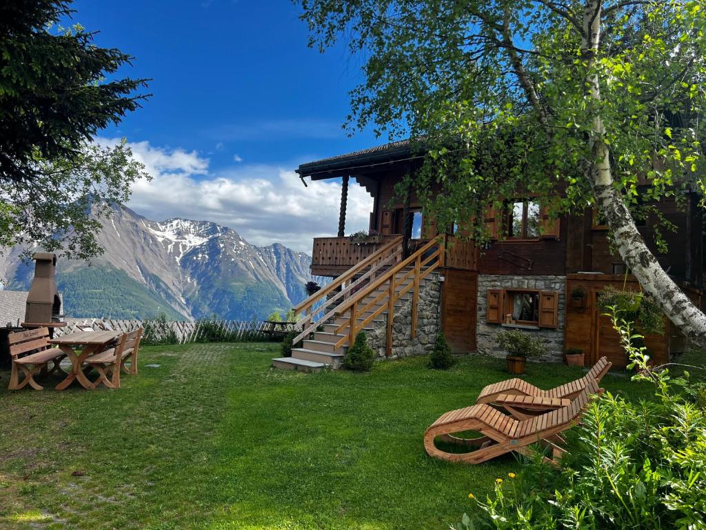 a log cabin with a table and benches in the yard at Chalet Tannenduft in Bettmeralp