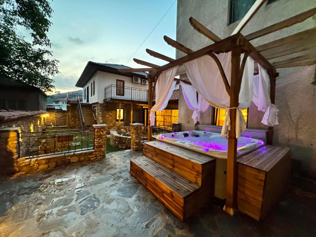 a hot tub in the backyard of a house at Rustik Home in Kotel