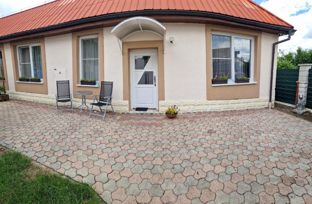 a house with a table and chairs in front of it at Apartman Kováčová in Kováčová