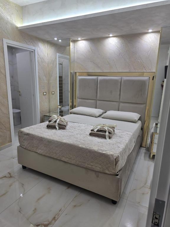 a bedroom with a large bed with two towels on it at B&B la marica in Adrano