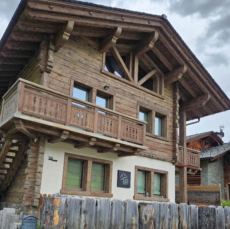 a wooden house with a balcony on top of it at Tilio Chalet in Livigno