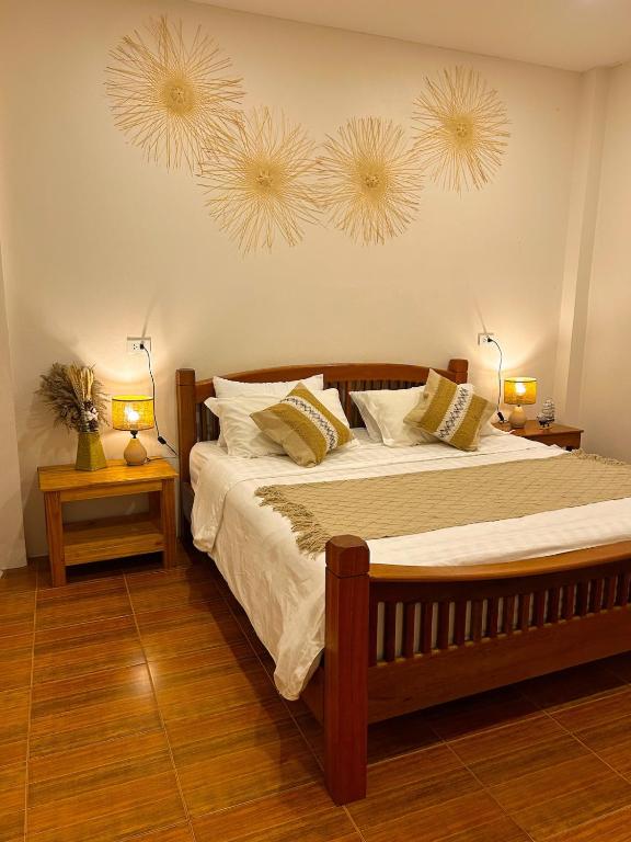 a bedroom with a large bed with two night stands at Jungle Hideaway with Pool Wifi Smart TV in Ban Tai