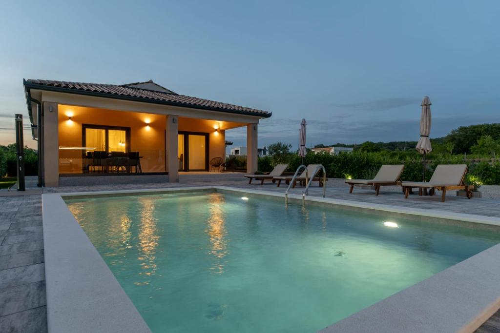 a swimming pool in front of a villa at Villa Ardanela in Labin
