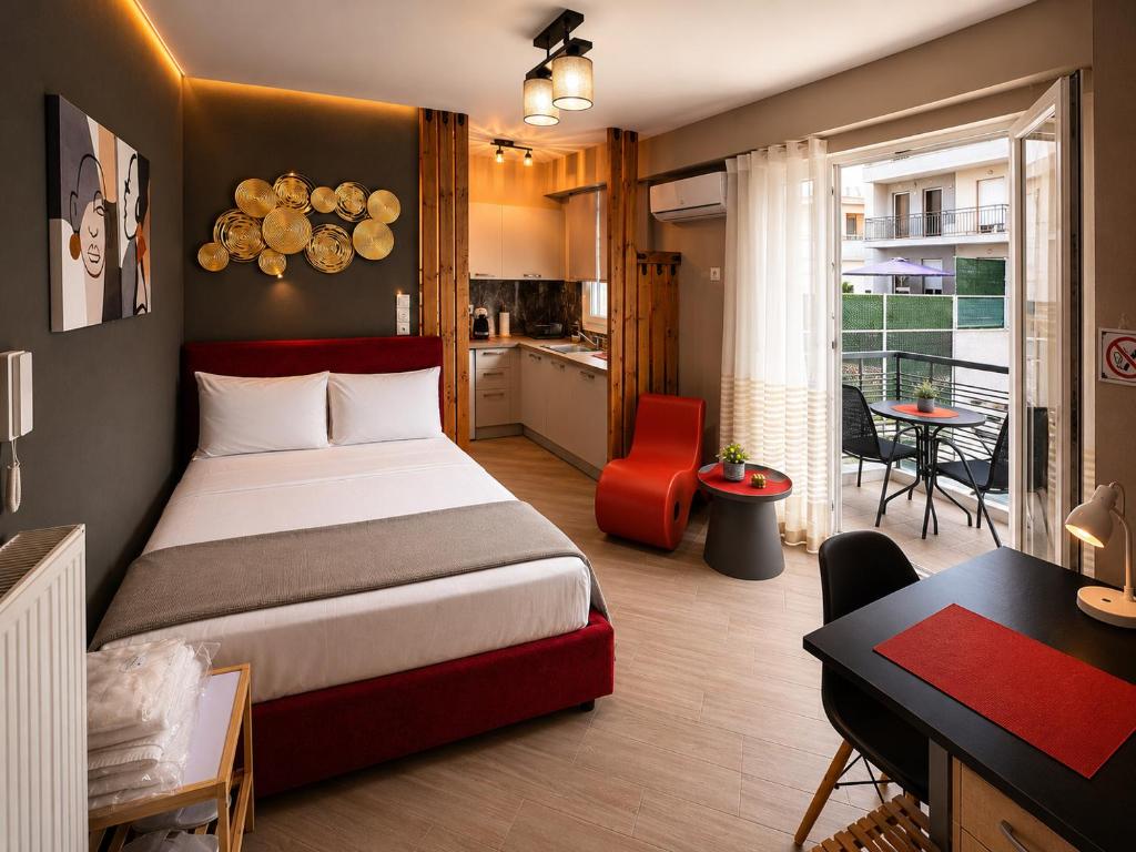 a bedroom with a bed and a desk and a kitchen at GPX CLR - MicroLuxe Suite in Larisa