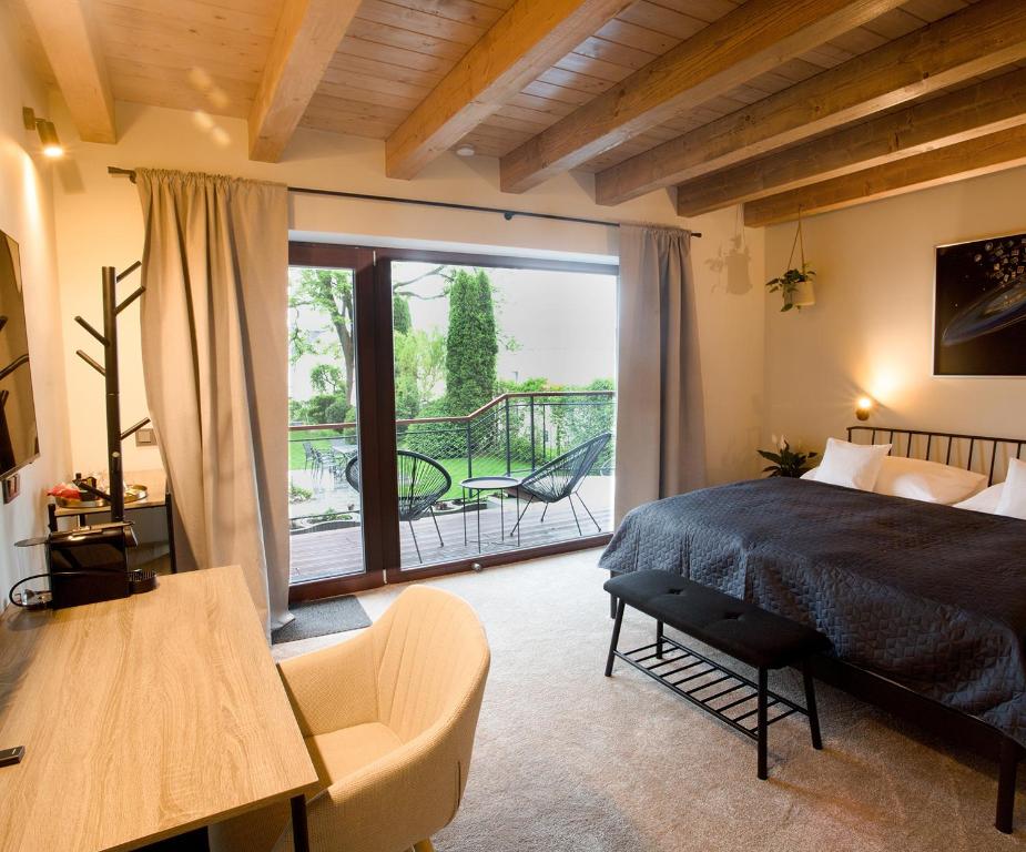 a bedroom with a bed and a balcony at Apart Hotel Jablonec in Jablonec nad Nisou