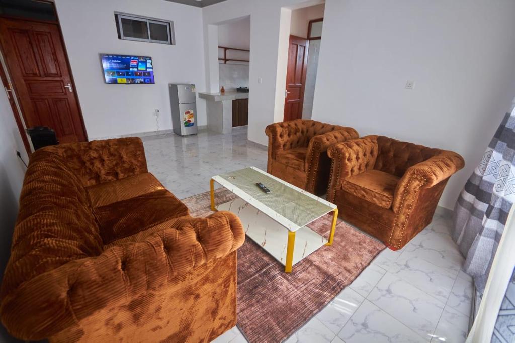 a living room with two couches and a coffee table at Talia holiday home ,Malindi kenya -1 in Malindi