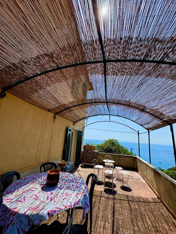 a patio with a table and chairs on a balcony at Appartamento con terrazza vista mare nel borgo in Framura