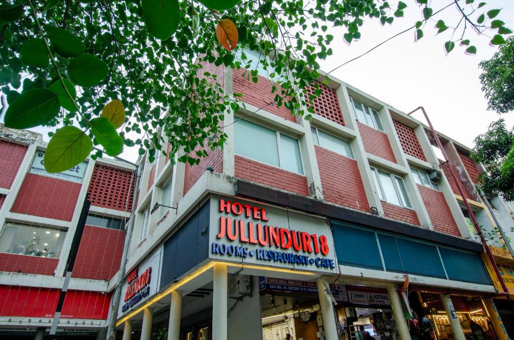 a building with a store sign in front of it at Hotel Jullundur 18 in Chandīgarh