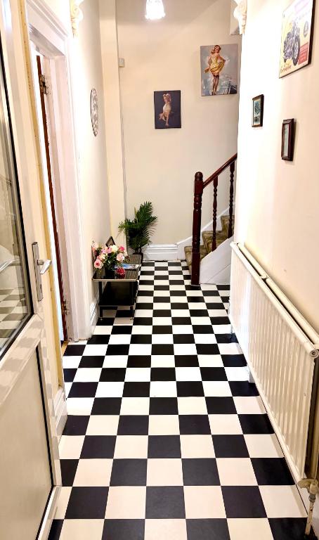 a hallway with a black and white checkered floor at Ramsgate Corner Retreat in Ramsgate
