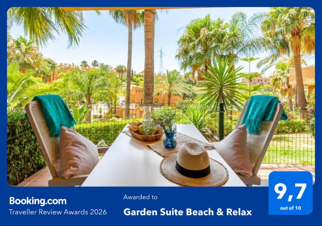 a table with a hat on it with palm trees at Garden Suite Beach & Relax in Mijas Costa