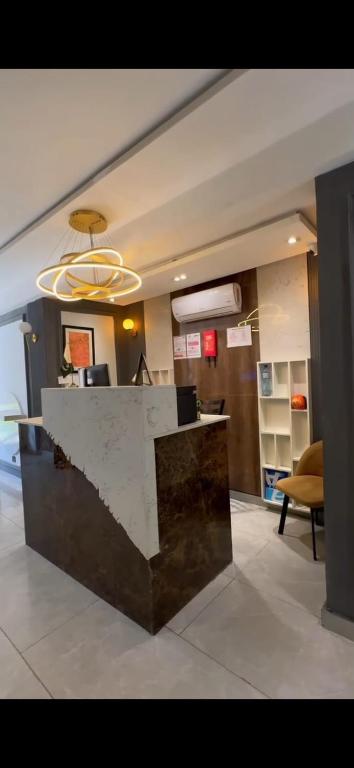 a lobby with a marble counter in a building at Emerald Inn in Islamabad
