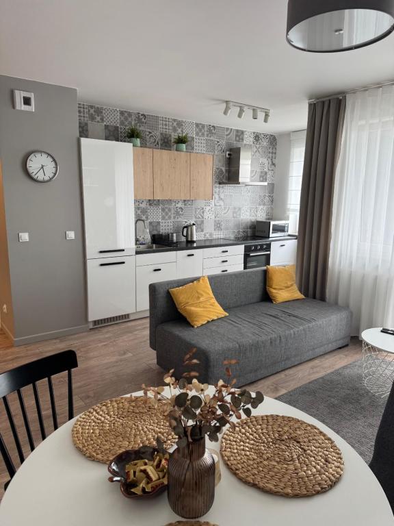 a living room with a couch and a table at Di Trevi Apartment in Wrocław
