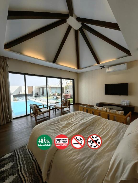 a bedroom with a large bed with stickers on it at منتجع تربل فور - Triple Four Resort in Buraydah
