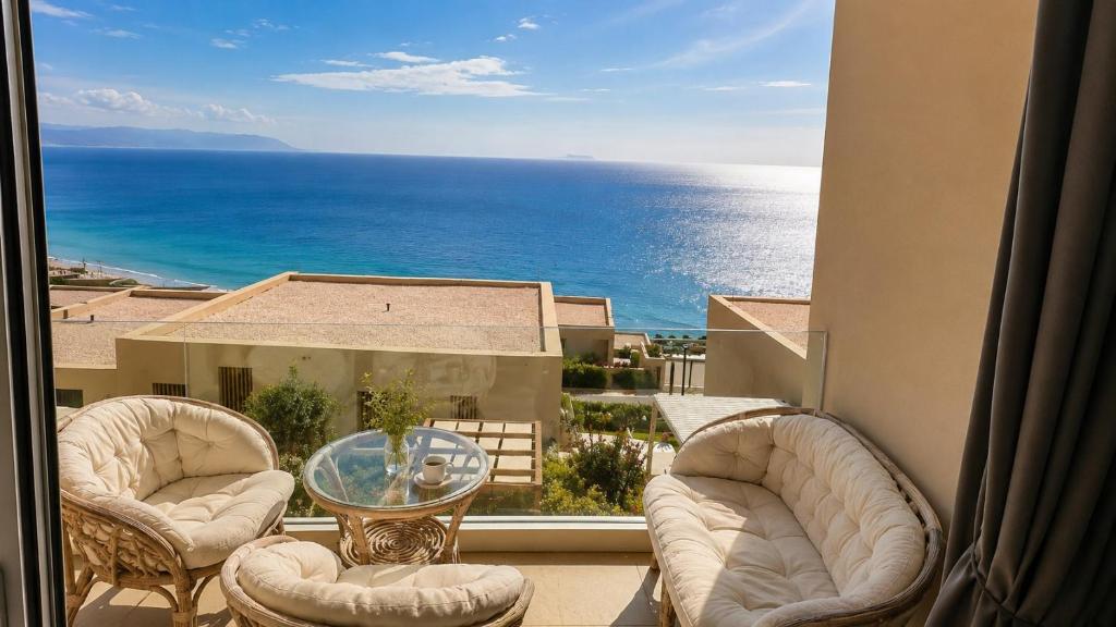 a view of the ocean from a balcony with chairs and a table at Green Coast Escape in Palasë