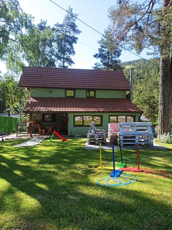 a house with a yard with a playground at Kuća za odmor-Aleksandra in Divčibare
