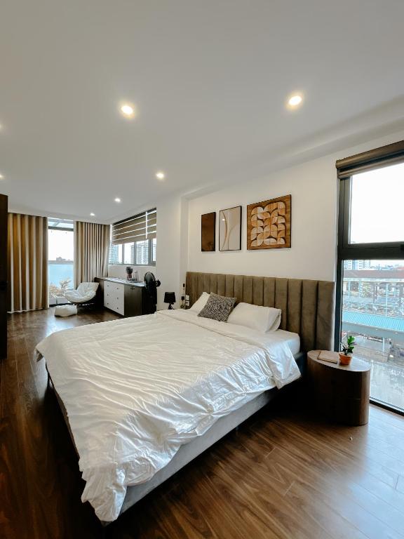 a bedroom with a large bed and a living room at Sky villas with large balcony in Hanoi
