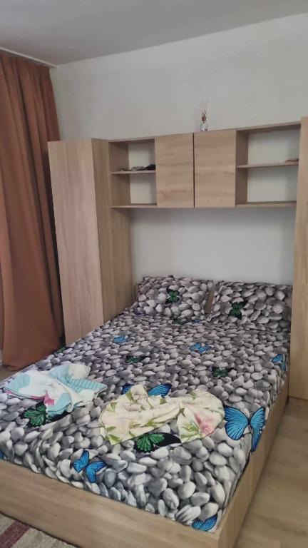 a bedroom with a bed with rocks on it at Vila Mirel in Eforie Nord