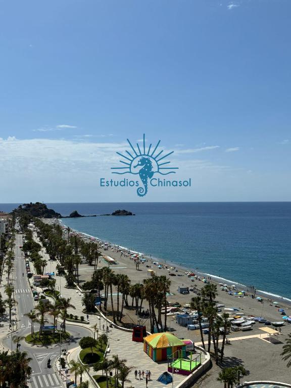 a view of the beach and the ocean at ESTUDIOS CHINASOL - Bernardo Cózar in Almuñécar