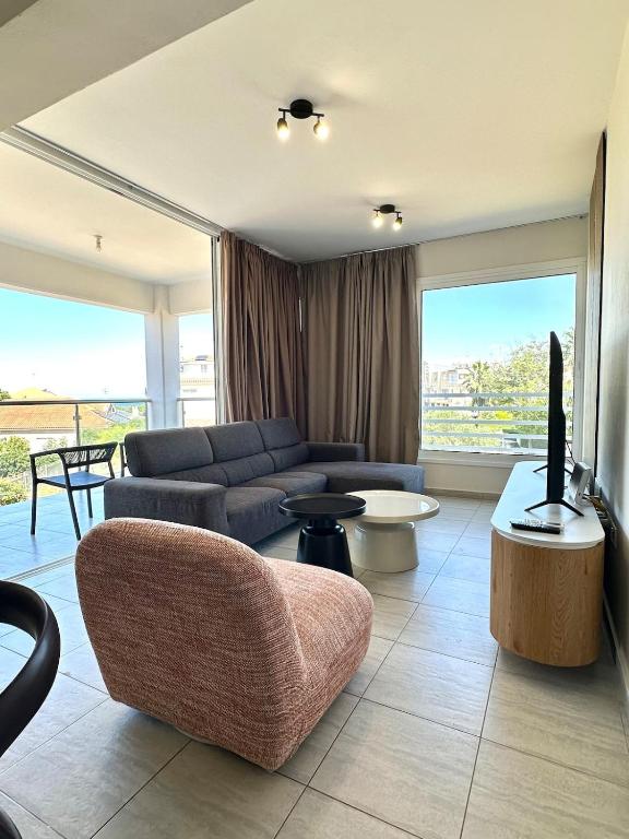 a living room with a couch and a tv at Bliss Getaway Near Protaras in Paralimni