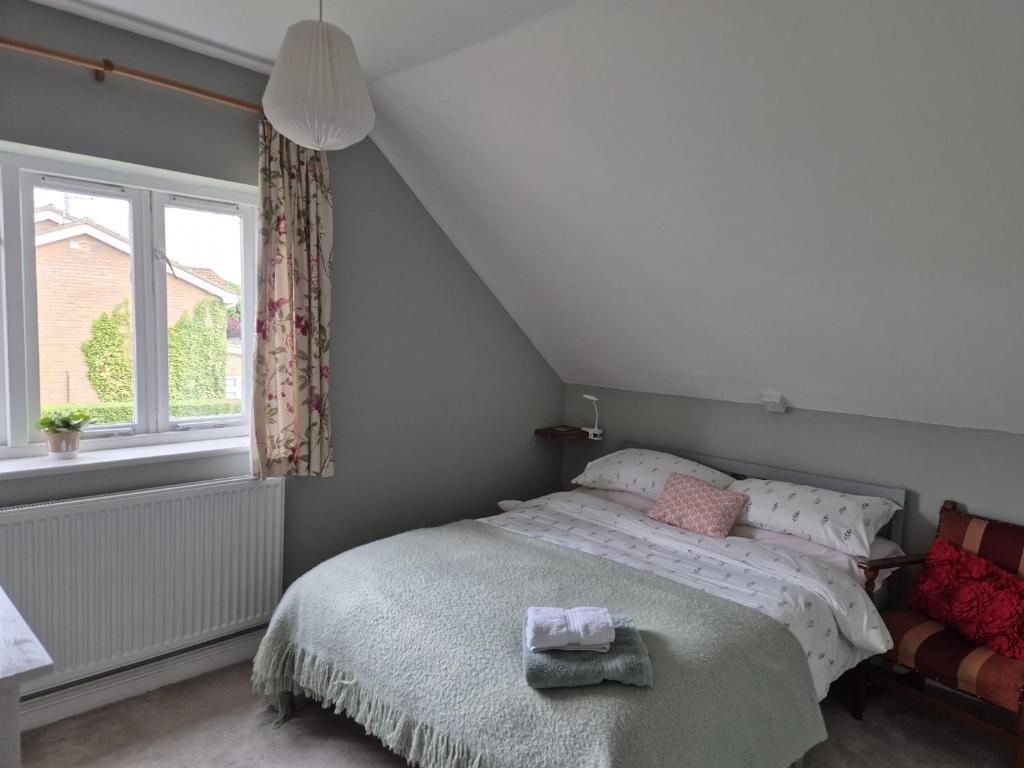 a bedroom with a bed and a window at Quiet Annexe in Oundle in Oundle