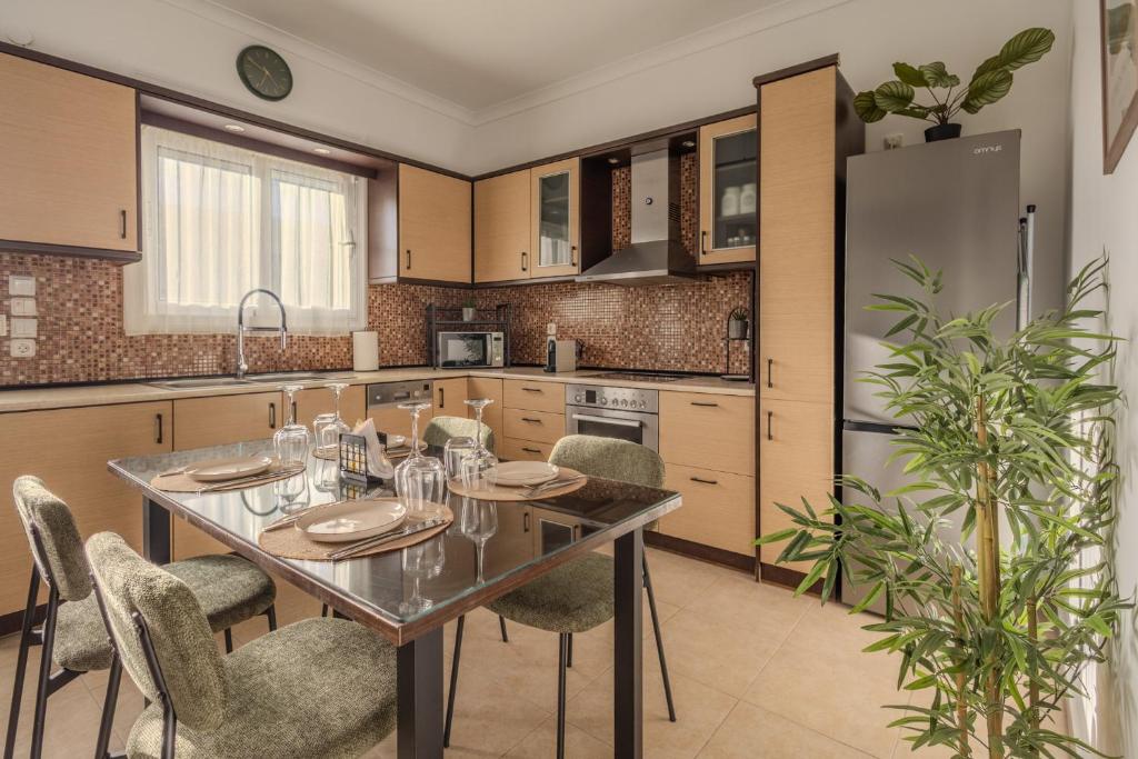 a kitchen with a table and chairs and a refrigerator at San House 1 in Archangelos