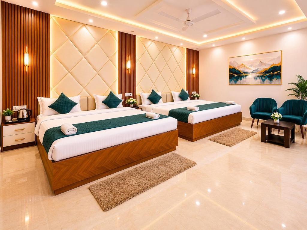a hotel room with two beds in a room at The Hotel Atlantis Suites Sigra Road Near Vishwanath Temple in Varanasi