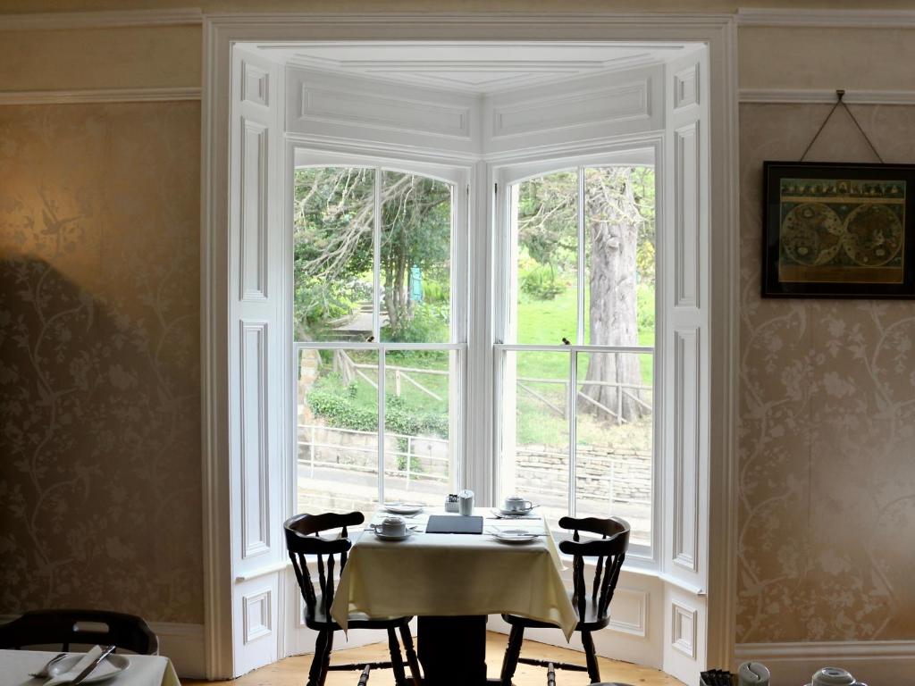 a dining room with a table and a window at The Florence Guest House in Whitby