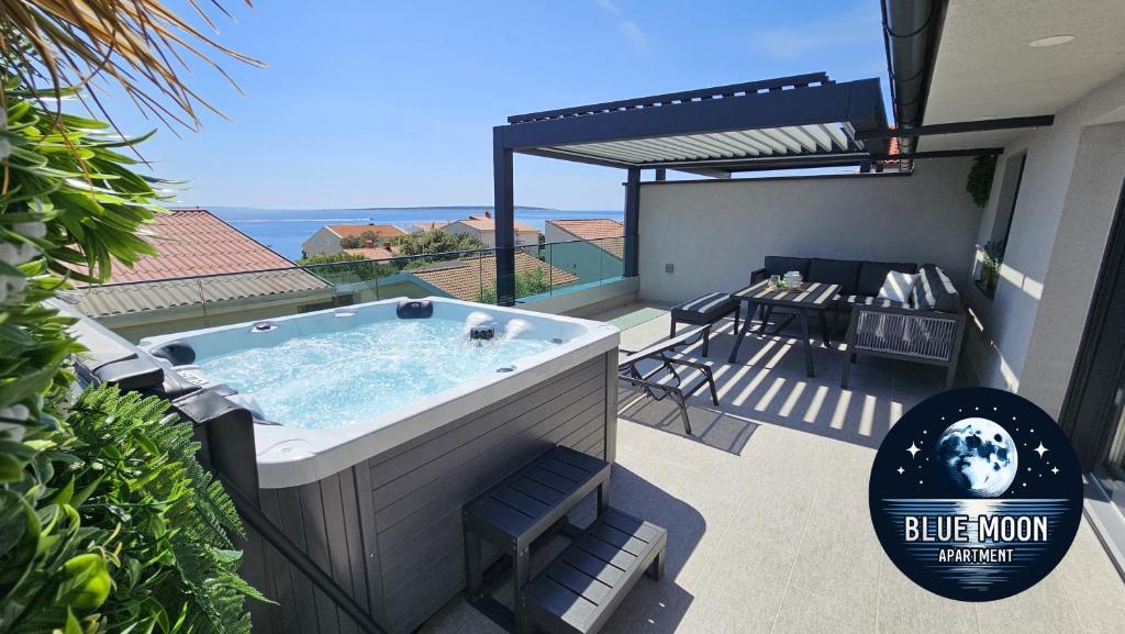 a hot tub on the balcony of a house at Blue Moon Apartment, now with Jacuzzi in Mandre