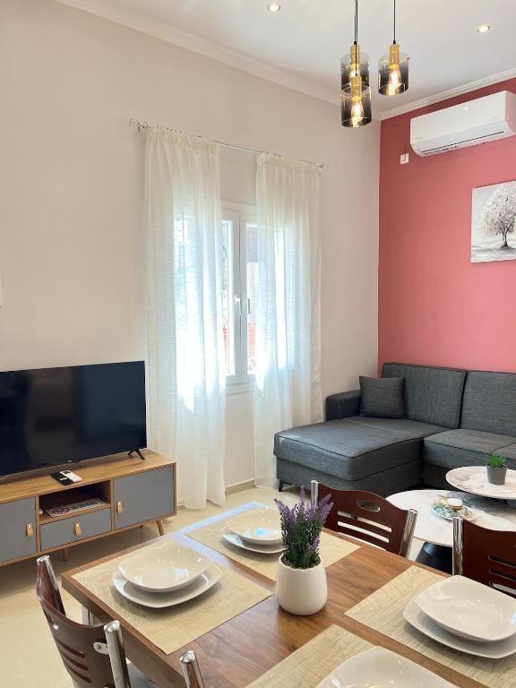 a living room with a couch and a dining room table at evelinas view 3 in Mytilene