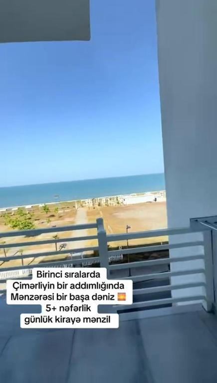 a sign on a building with a beach in the background at Terras Astara in Astara