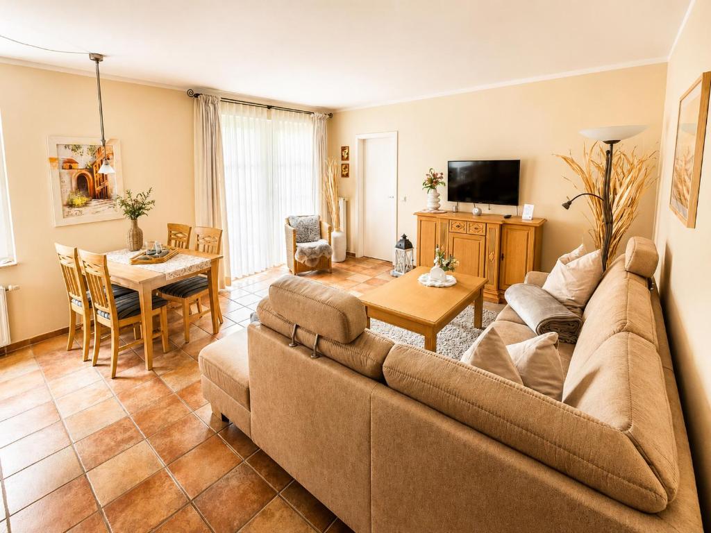 a living room with a couch and a table at Apartmenthaus Ostseewelle Ferienwohnung 13 in Kühlungsborn