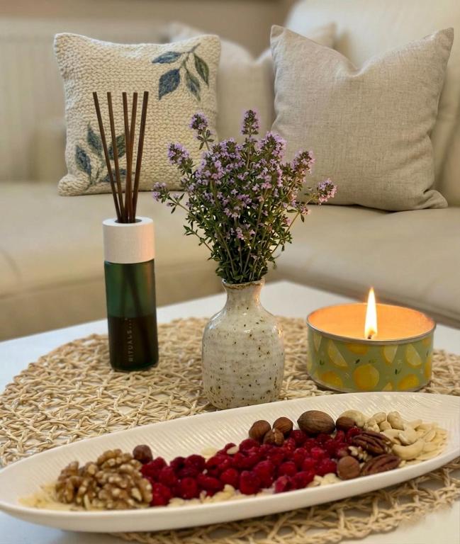 a plate of food on a table with a candle at Apartmán Tymián in Vyšné Ružbachy