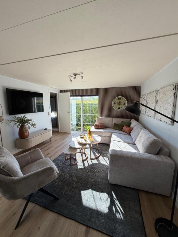 ein Wohnzimmer mit zwei Sofas und einem Tisch in der Unterkunft It Paradys in Dronrijp