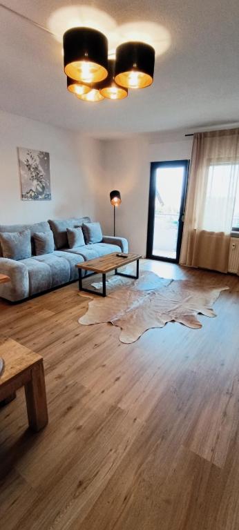 a living room with a couch and a table at Stilvolle Wohnung in Waldbrunn in Waldbrunn