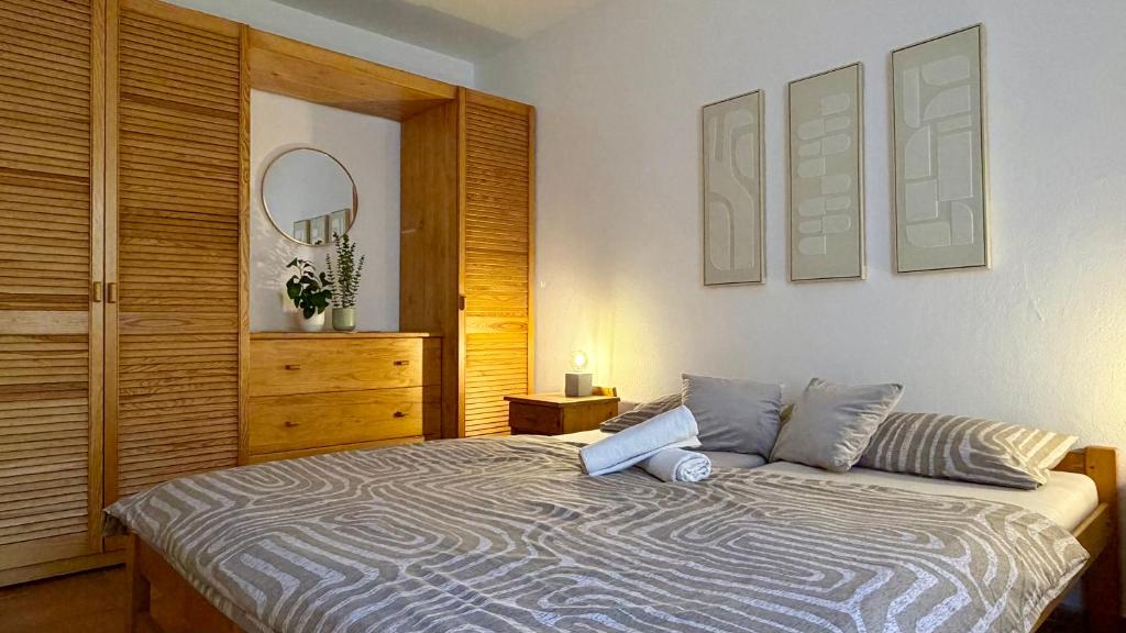 a bedroom with a bed and a dresser and a mirror at HollidayVillage 5B in Matka Božia