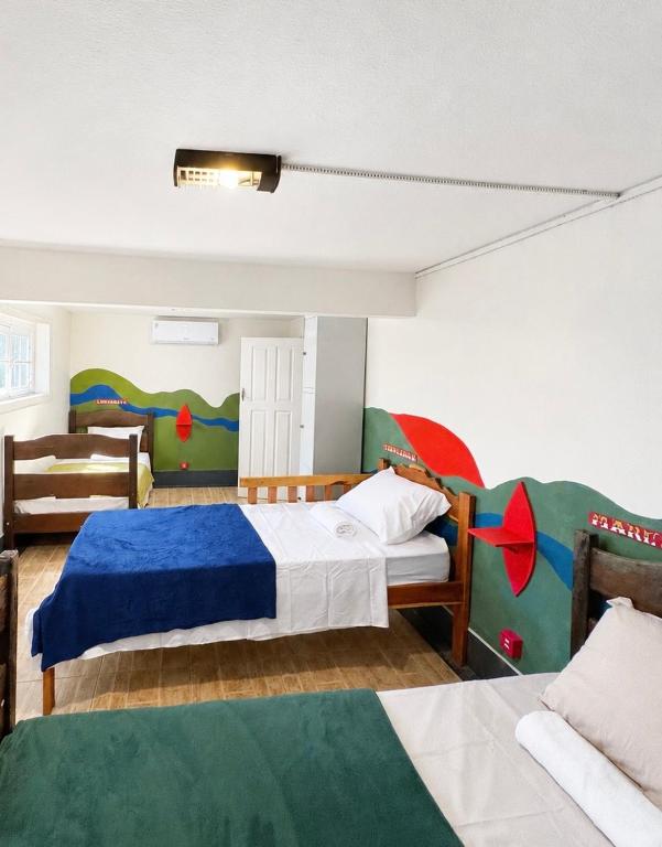 a bedroom with two beds and a couch at Casa Igara Hostel in Belém