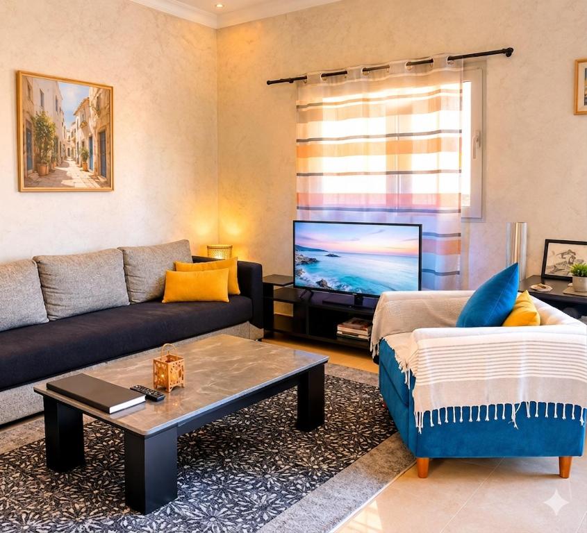 a living room with a couch and a tv at appartement chaleureux in Oran