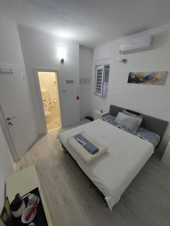 a bedroom with a large bed in a room at Rooms By the way M17 in Vrapčići