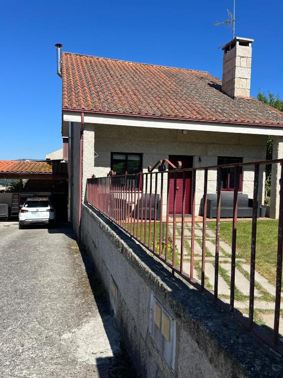 a house with a fence in front of it at Casita Arnoia in Allariz