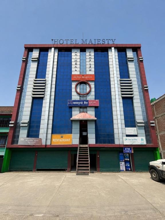 a blue and white building with a staircase in front at Hotel Majesty Katari in Tribeni Ghāt