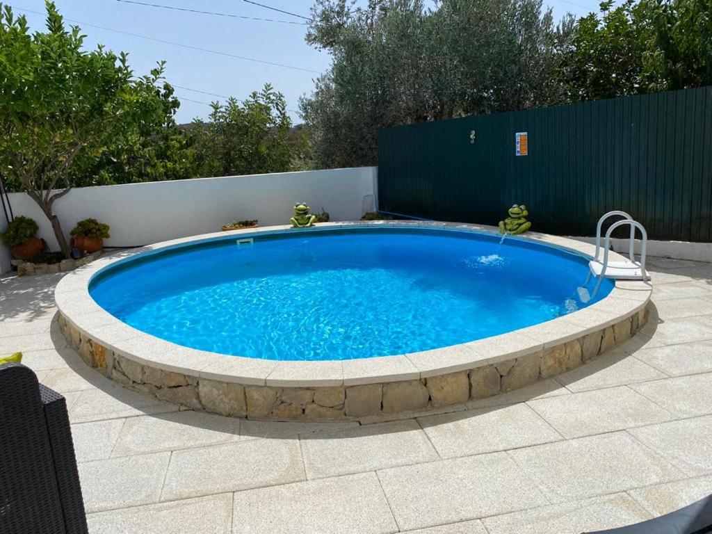 a large swimming pool in a circle on a patio at Casa dos Avós in São Brás de Alportel