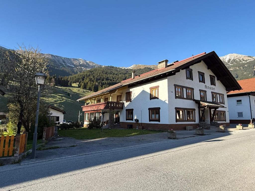 a large white house on the side of a street at Haus Krone in Lähn