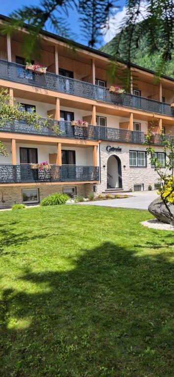 a large building with a lawn in front of it at Pension Gstrein in Bad Hofgastein