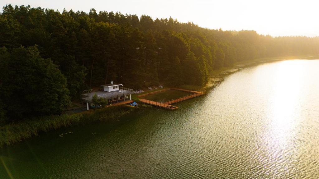 an aerial view of a house on the shore of a lake at Long Vita in Przewóz