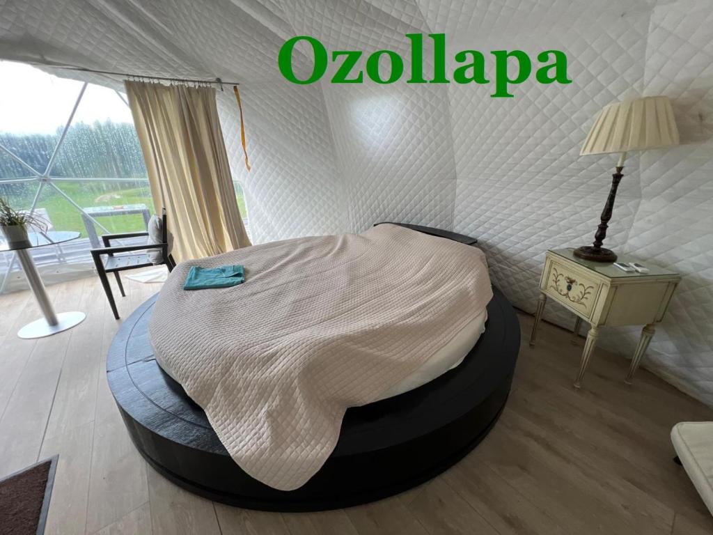 a bedroom with a bed in a tent at Ozols in Vecpiebalga