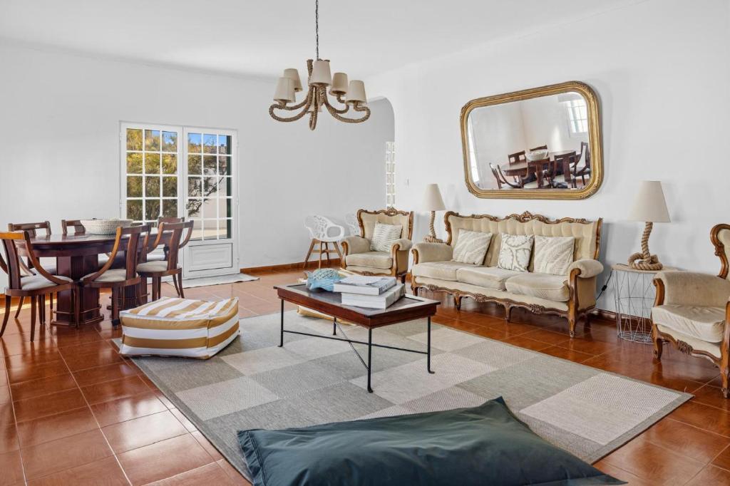 a living room with a couch and a table at Casa MiRaMar in Mosteiros
