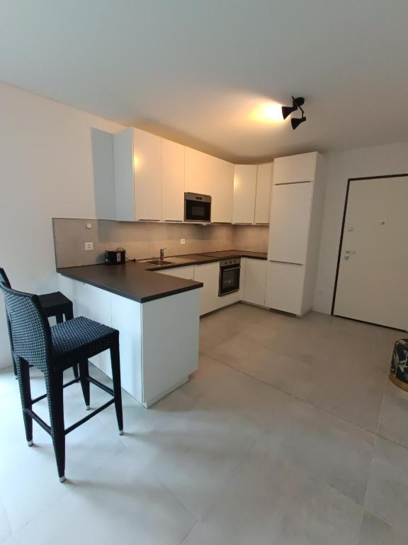 a kitchen with a table and a chair in a room at Paradise 31 in Paradiso