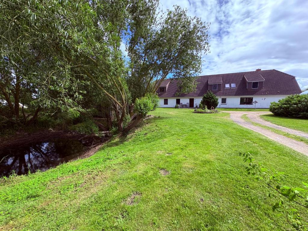 a house with a grassy yard in front of a house at Schnitterkaserne in Schaprode 7B in Schaprode