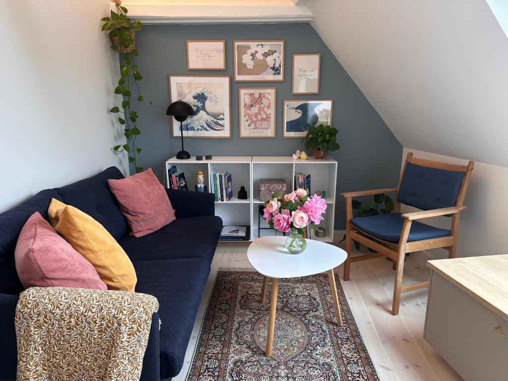 a living room with a blue couch and a table at Old Town Loft Middelfart in Middelfart