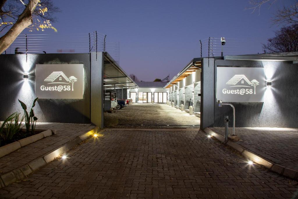 a building with signs on the side of it at night at Guest at 58 in Lydenburg